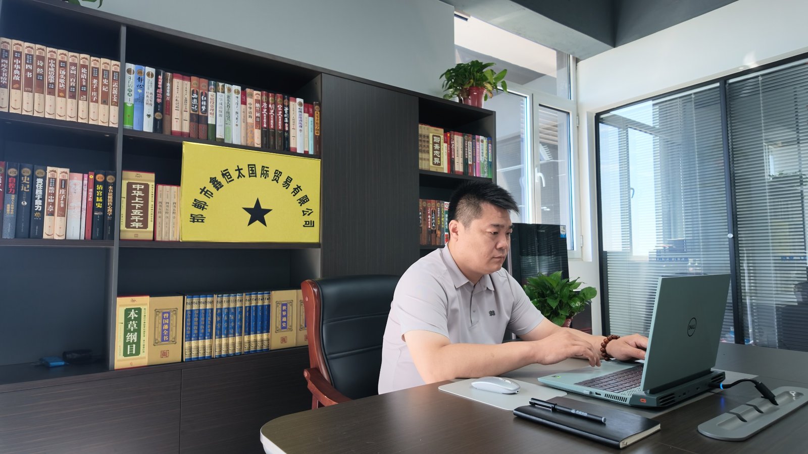 Real XHT office with a team member working at a computer
